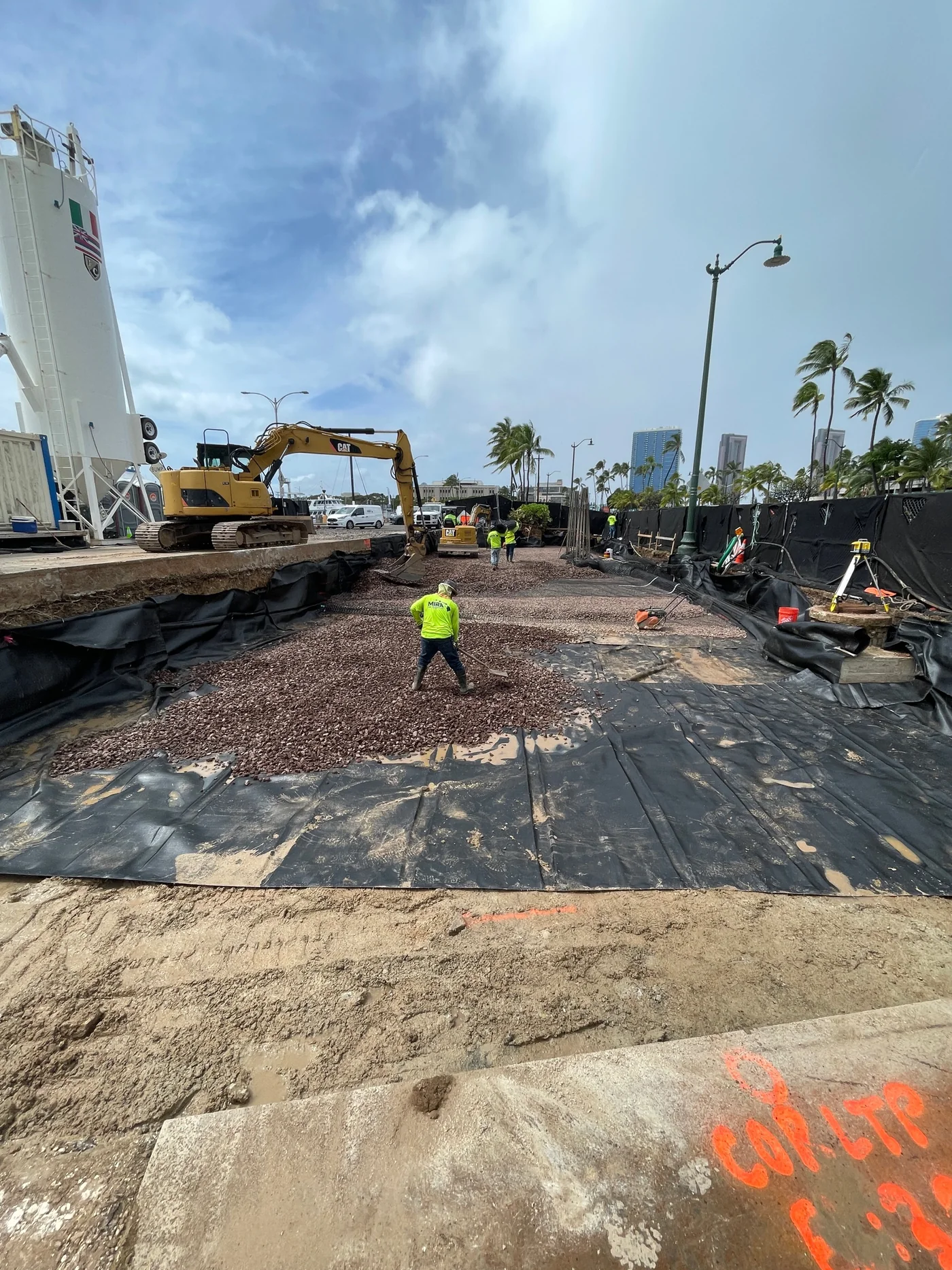 Excavation and equipment work at the pedestrian-walkway project site.