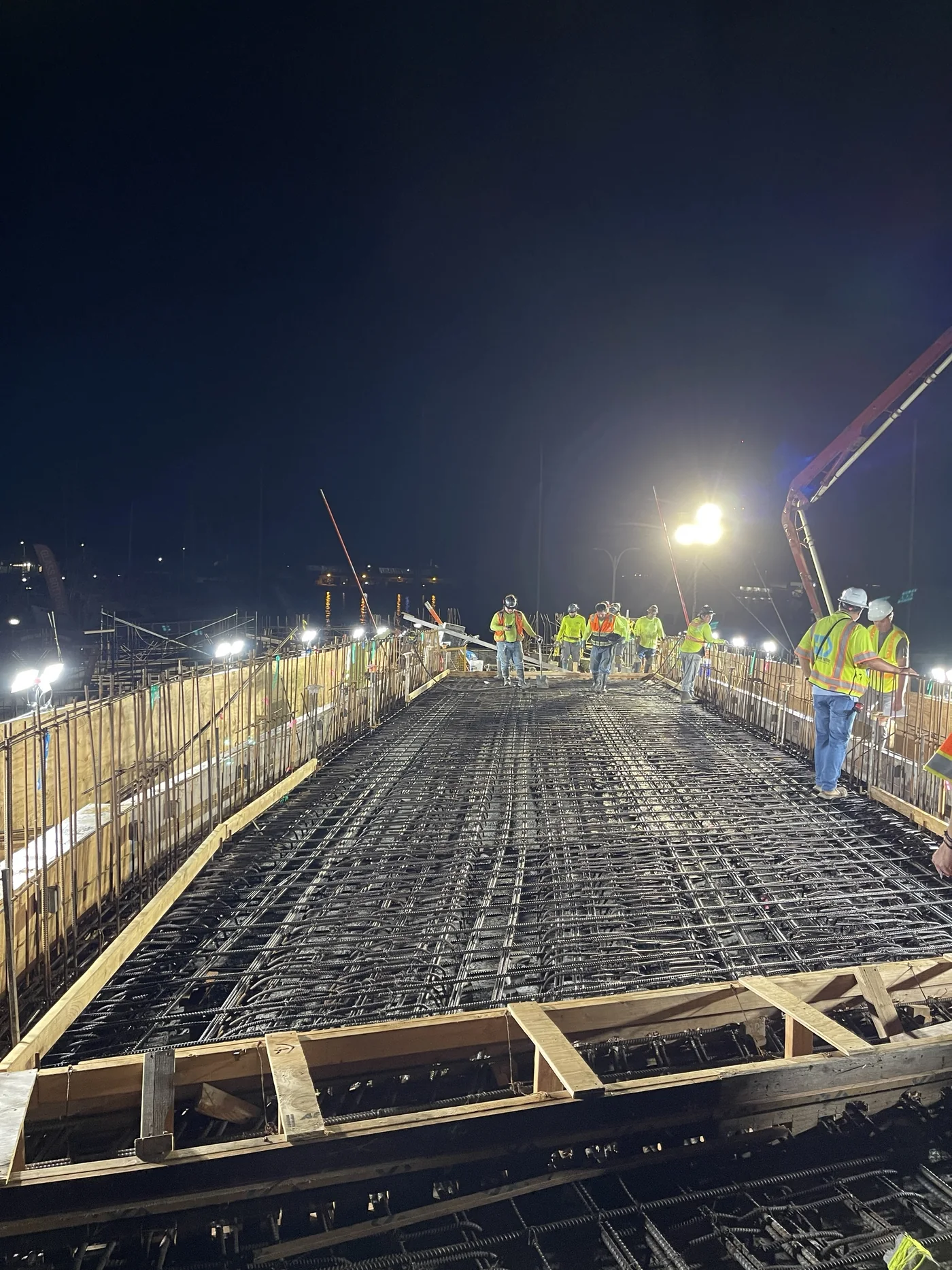 MIRA crew preparing reinforcing steel for a nighttime bridge-deck concrete pour.