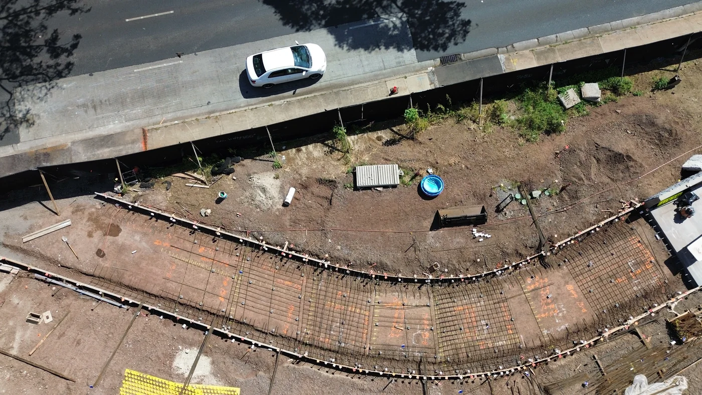MIRA crew finishing fresh concrete on the walkway structure.