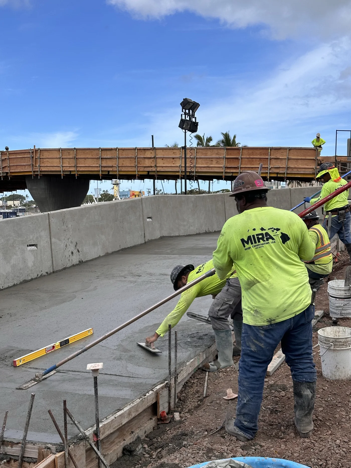 Elevated pedestrian walkway structure and crew at the project site.