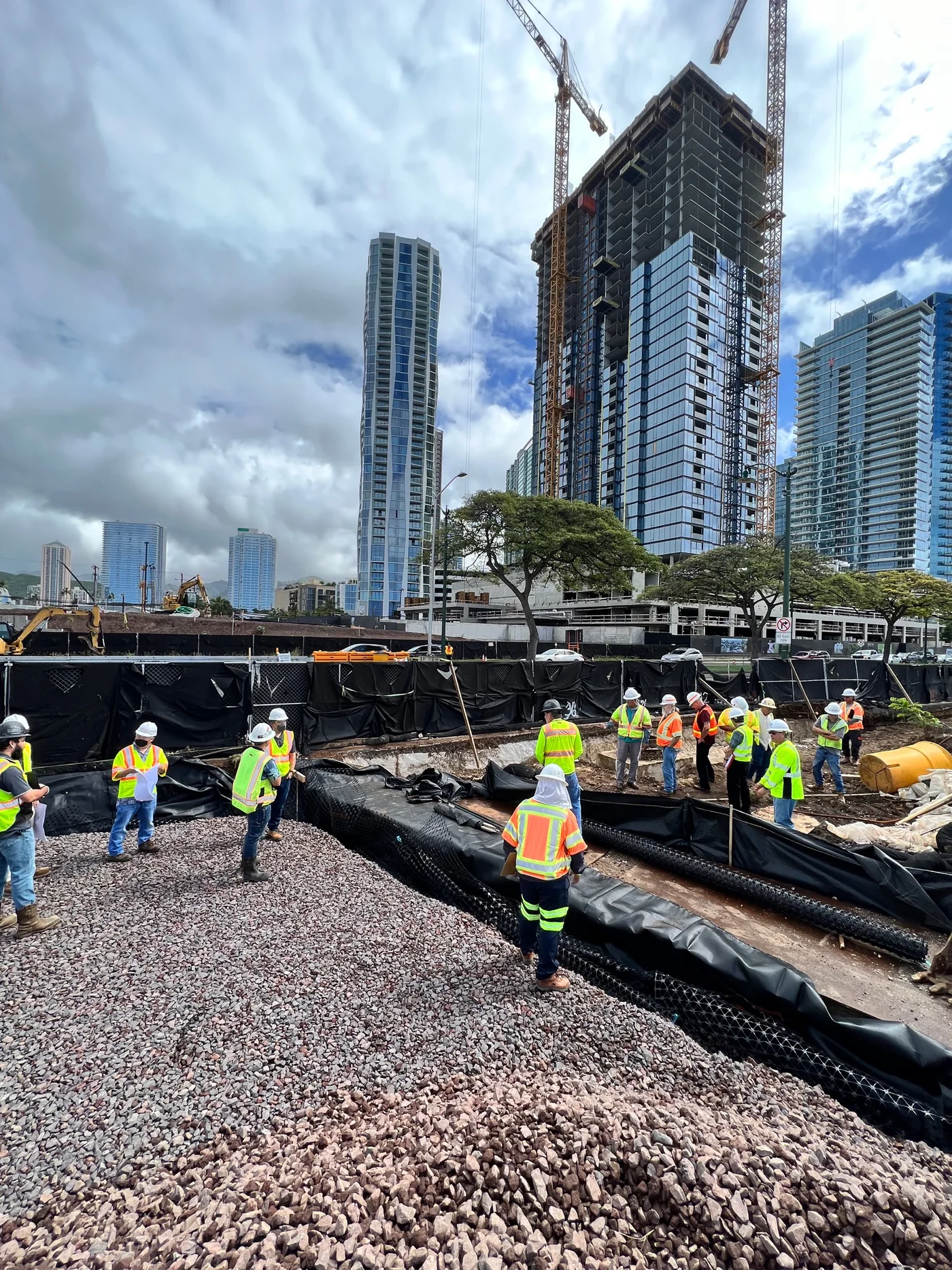 Civil work and utility coordination near the future walkway alignment.