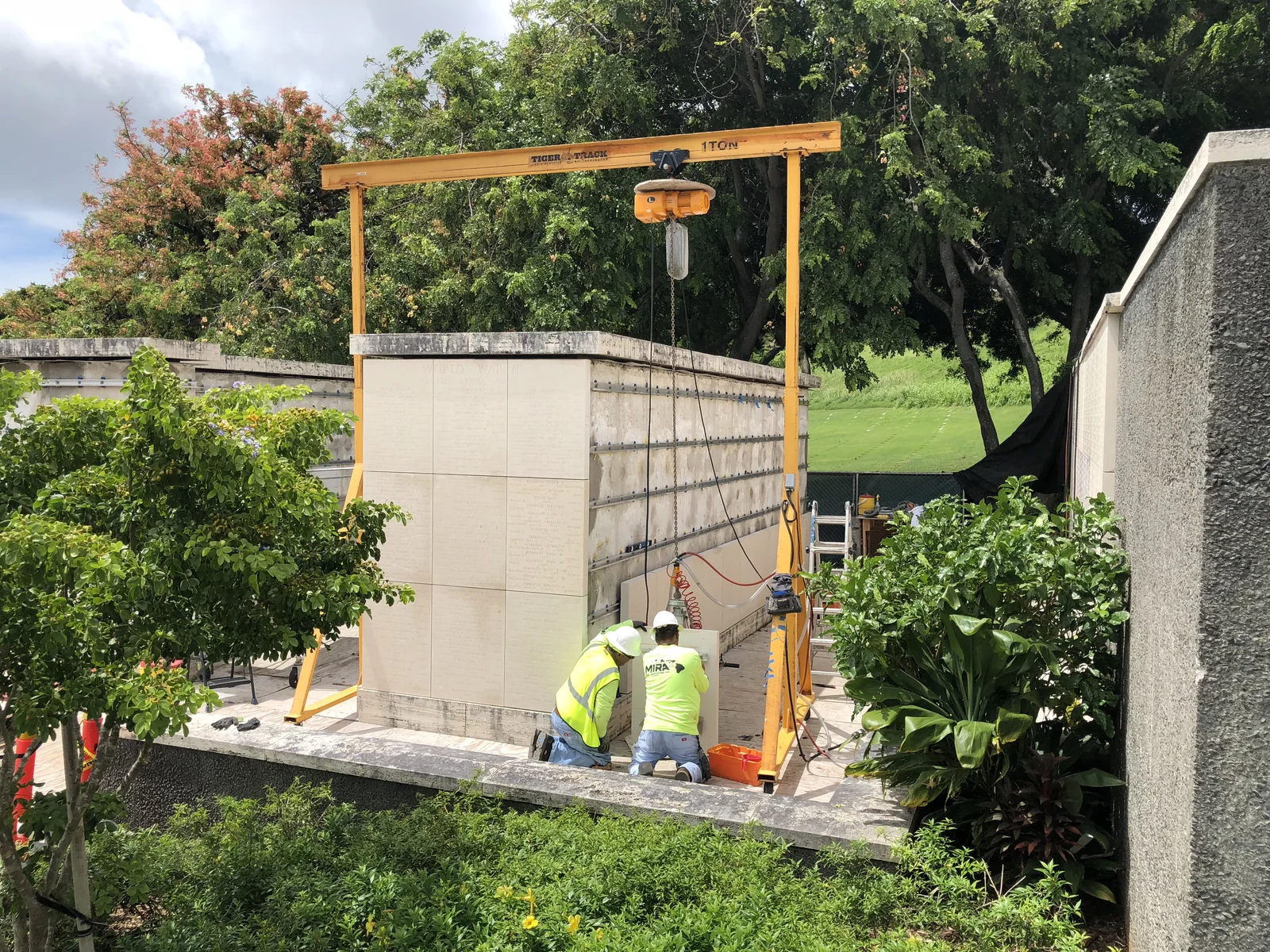 MIRA craftworkers installing stone panels at the memorial.