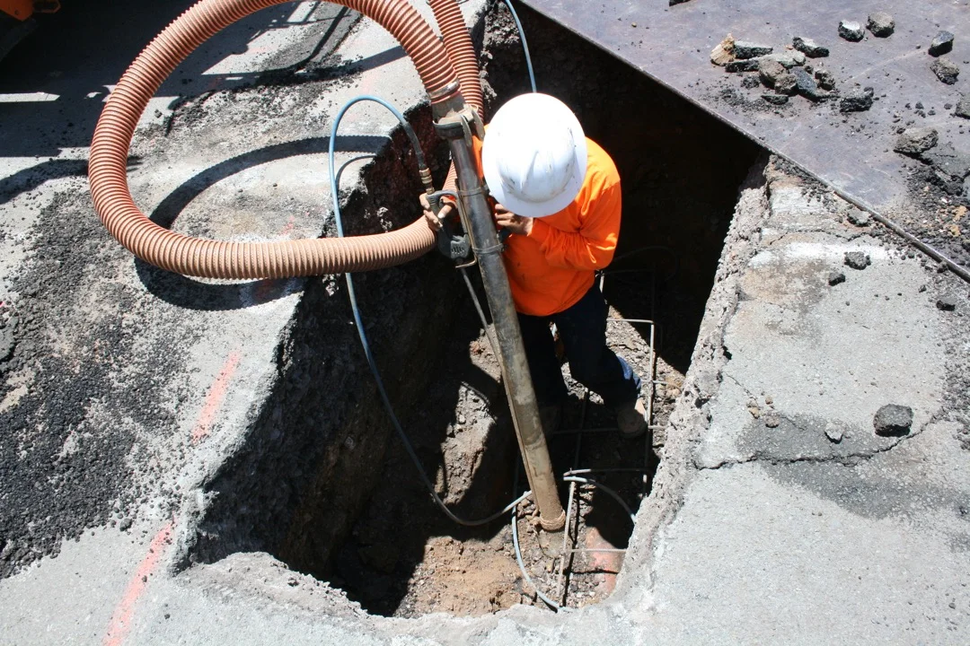 Utility construction with traffic control in a dense Honolulu neighborhood.
