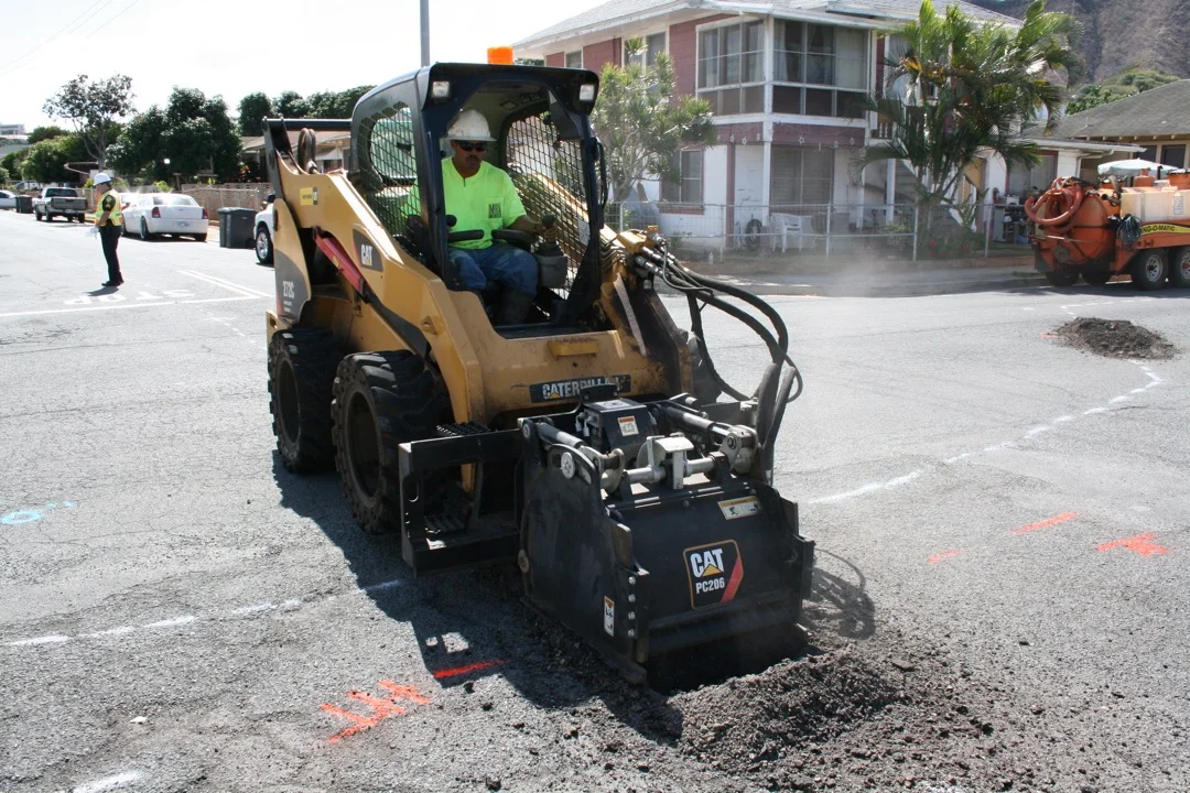 MIRA equipment completing pavement removal for the Kapahulu waterline.