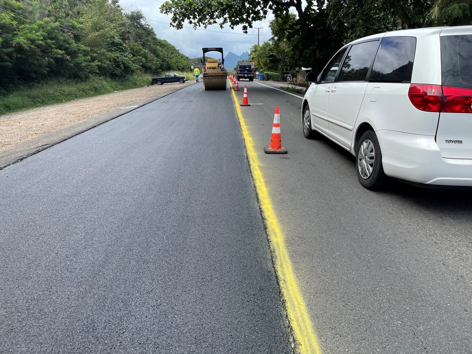 MIRA roadway work in progress with paving, traffic control, and crew equipment on Oʻahu.